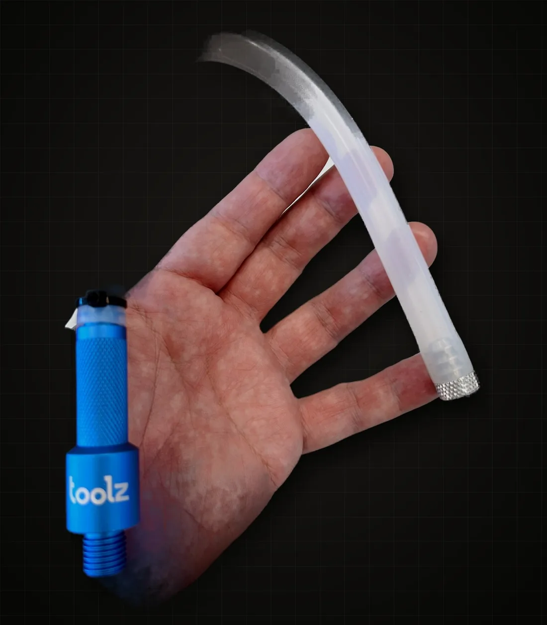 A blue Oil Drain Tool with the clear silicone hose and bung, held in a hand